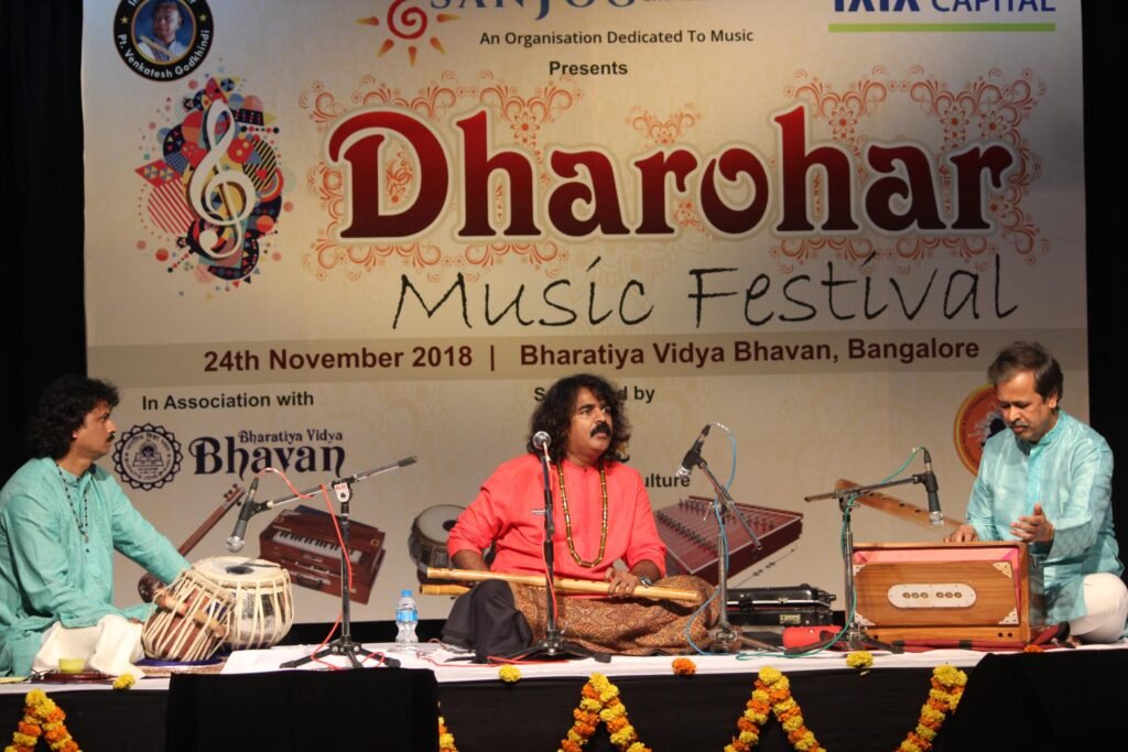 Students in red kurtas performing in a group recital